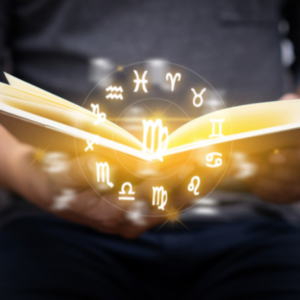 man holding a book with a gold floating circle of zodiac signs